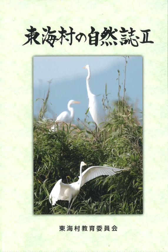 東海村の自然誌2、東海村教育委員会：草の葉の生い茂る中の3羽の白い大きな鳥の写真。手前の1羽は大きく羽を広げている